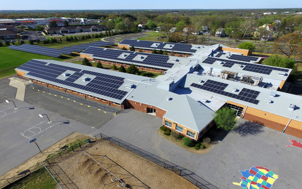 Drone photo of a roof of a school in New Jersey full of solar panels.